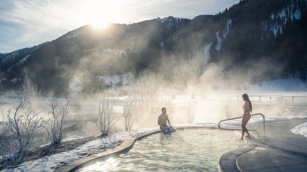 People getting into a hot spring pool in Wyoming's mountains.