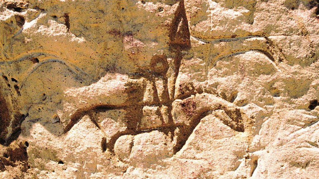 A petroglyph depicting a man riding a horse on White Mountain, a top thing to do for history enthusiasts.