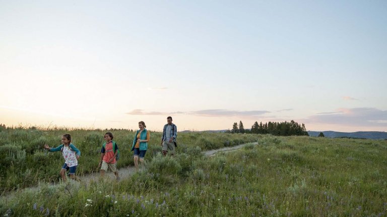 Family hiking together in Wyoming, an important family travel activity.