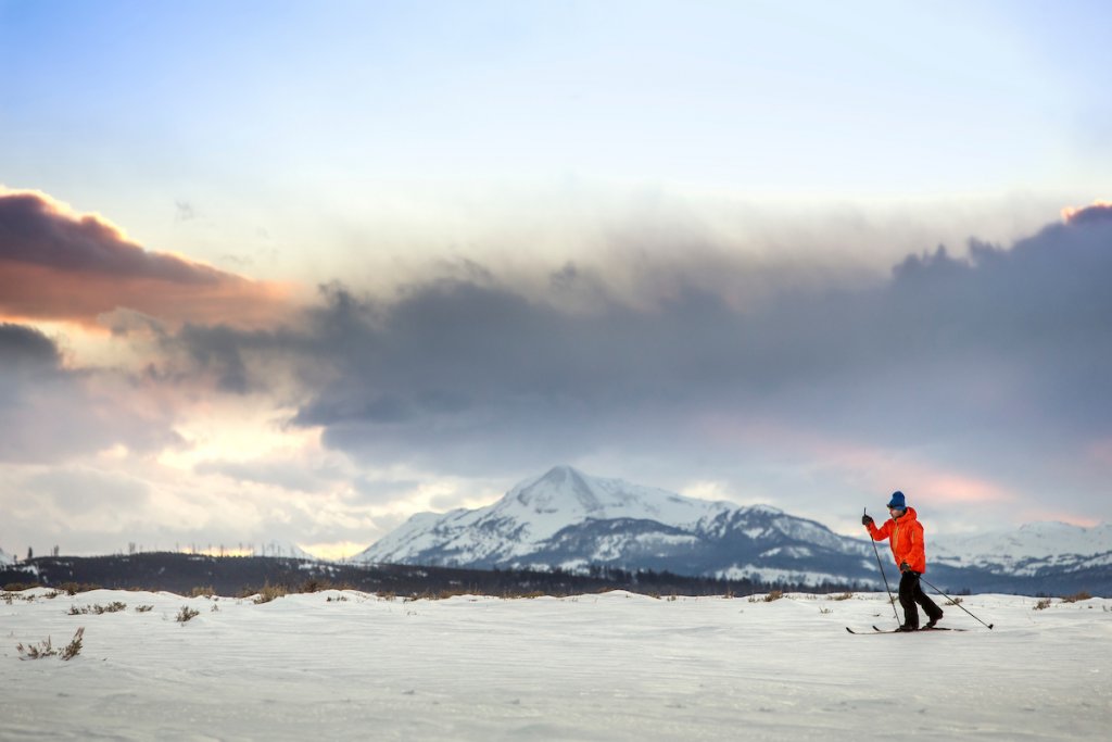 A visitor skis across snowy fields in Yellowstone