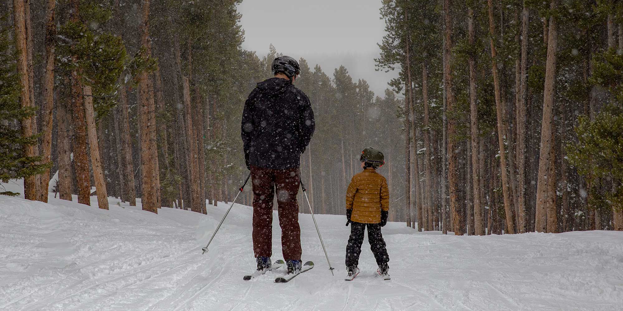 Father and son at Snowy Range Ski Area while it is snowing 