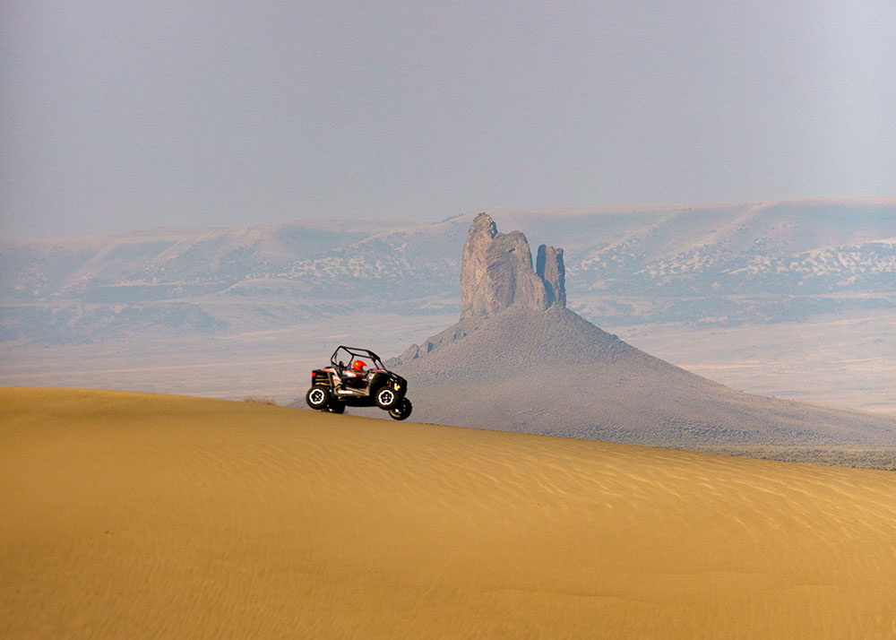 A person on an ATV at Killpecker Sand Dunes.