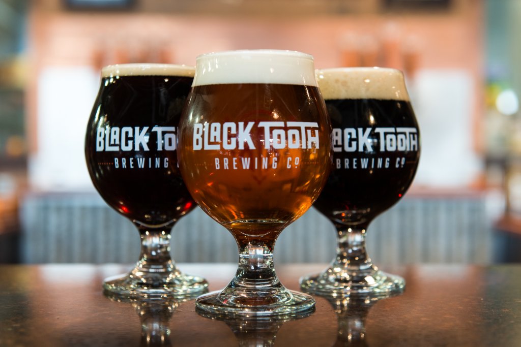 Delicious beers sitting atop the bar to Black Tooth Brewing Co, a popular craft brewery in Wyoming.