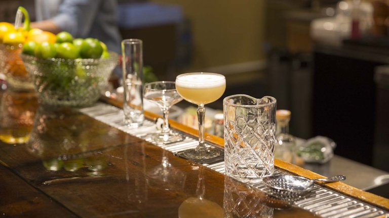 Glasses of delicious cocktails line a bar in one of Wyoming's many craft breweries and distilleries.