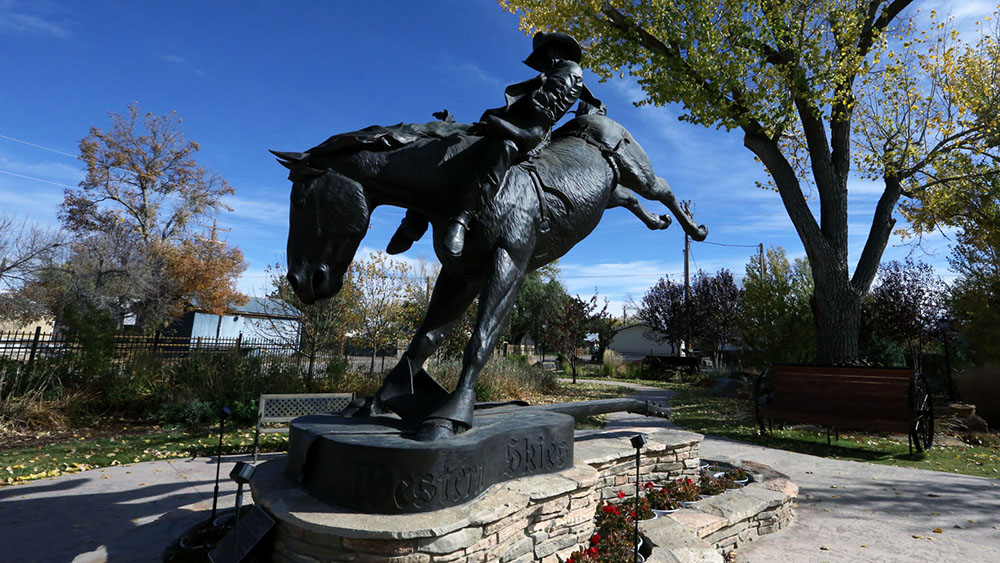 A statute of a man on a horse at Chris LeDoux memorial park, a stop in Kaycee Wyoming