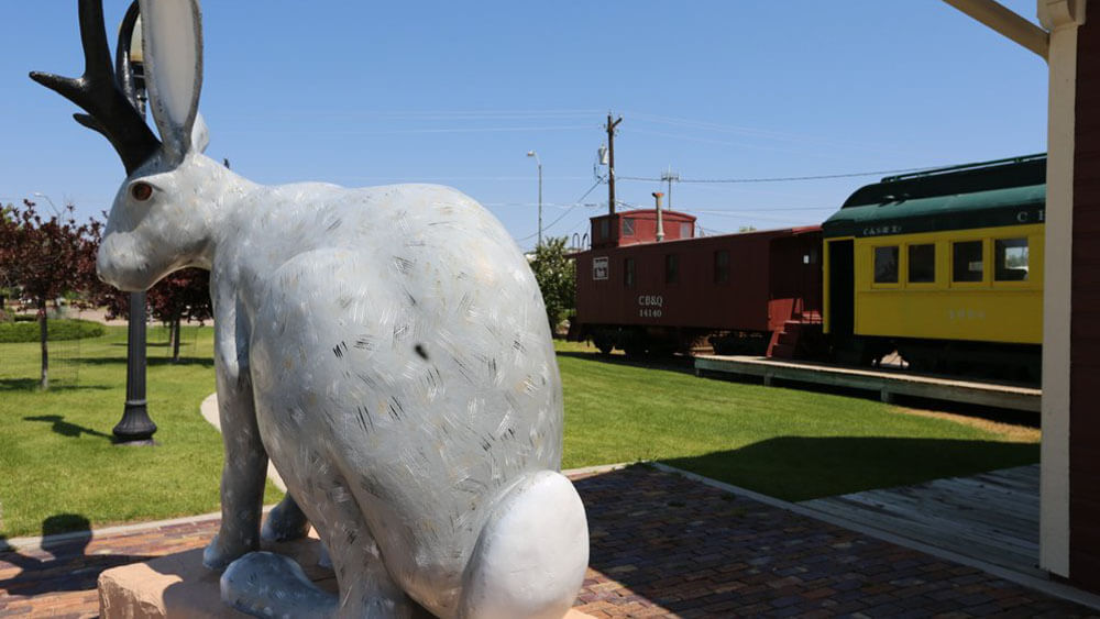large jackalope statue and trains