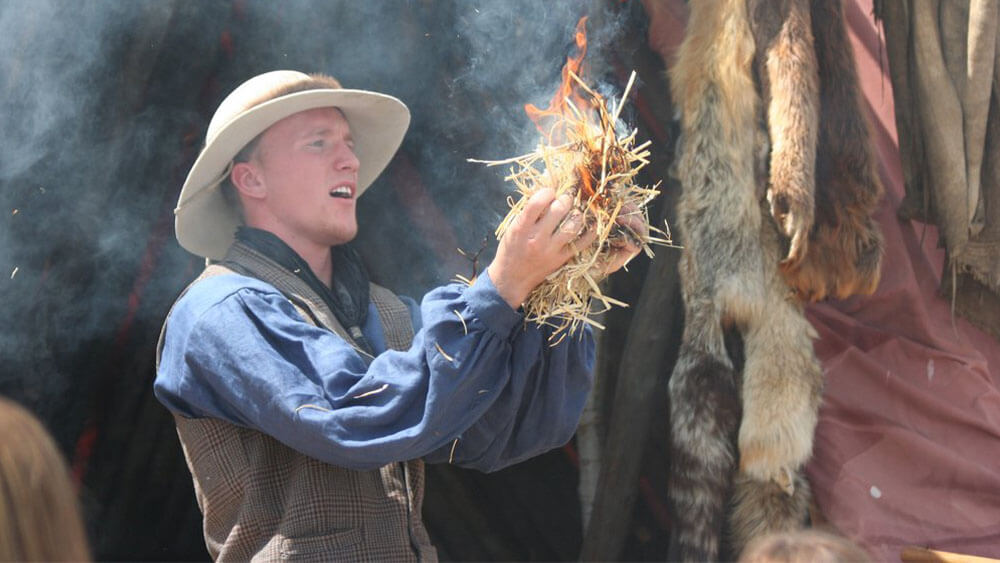 An actor demonstrating how pioneers lived in Wyoming during Green River Rendezvous, a popular event in Wyoming.