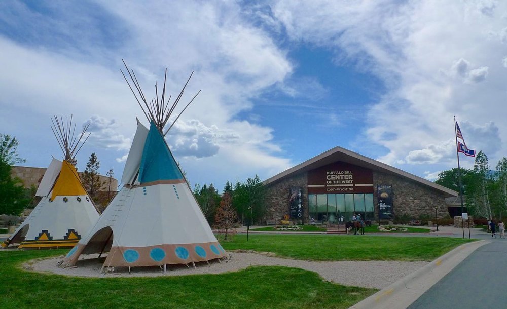 Exterior of the Buffalo Bill Center of the West in Wyoming, with teepees out front. 