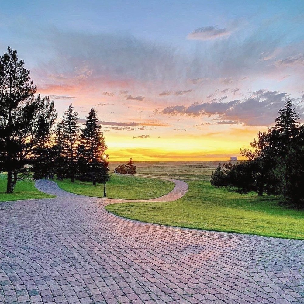 drive way area with a sunset in tow of Little America Hotel & Resort, a wedding venue in Wyoming.