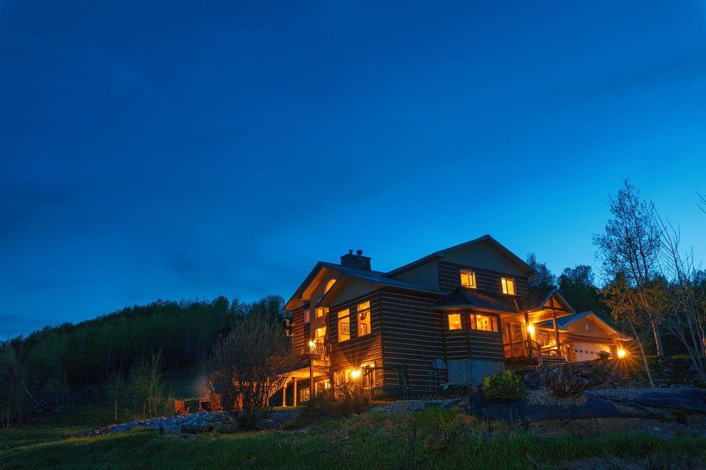 Night sets upon Star Valley Lodge, a wedding venue and lodge in Wyoming.