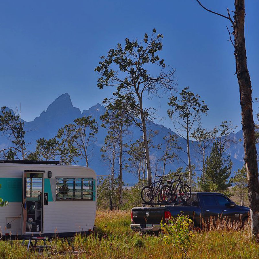 Truck and RV in front of the Teton Mountains.