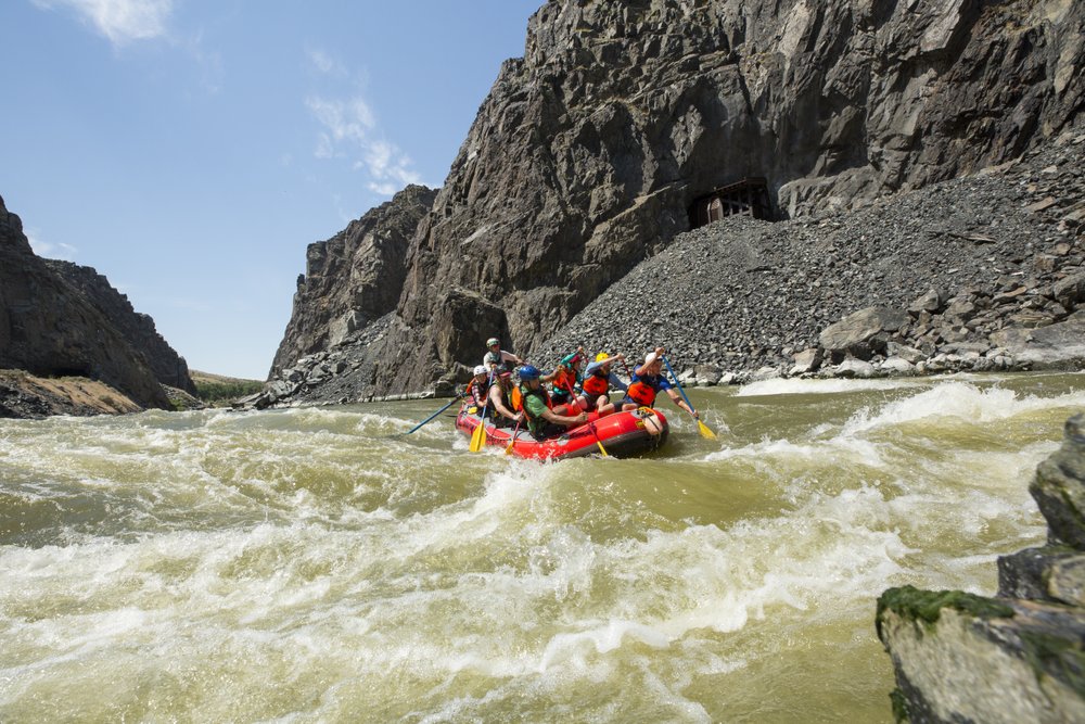 A group of people whitewater rafting through a lake in the Wind River Range 