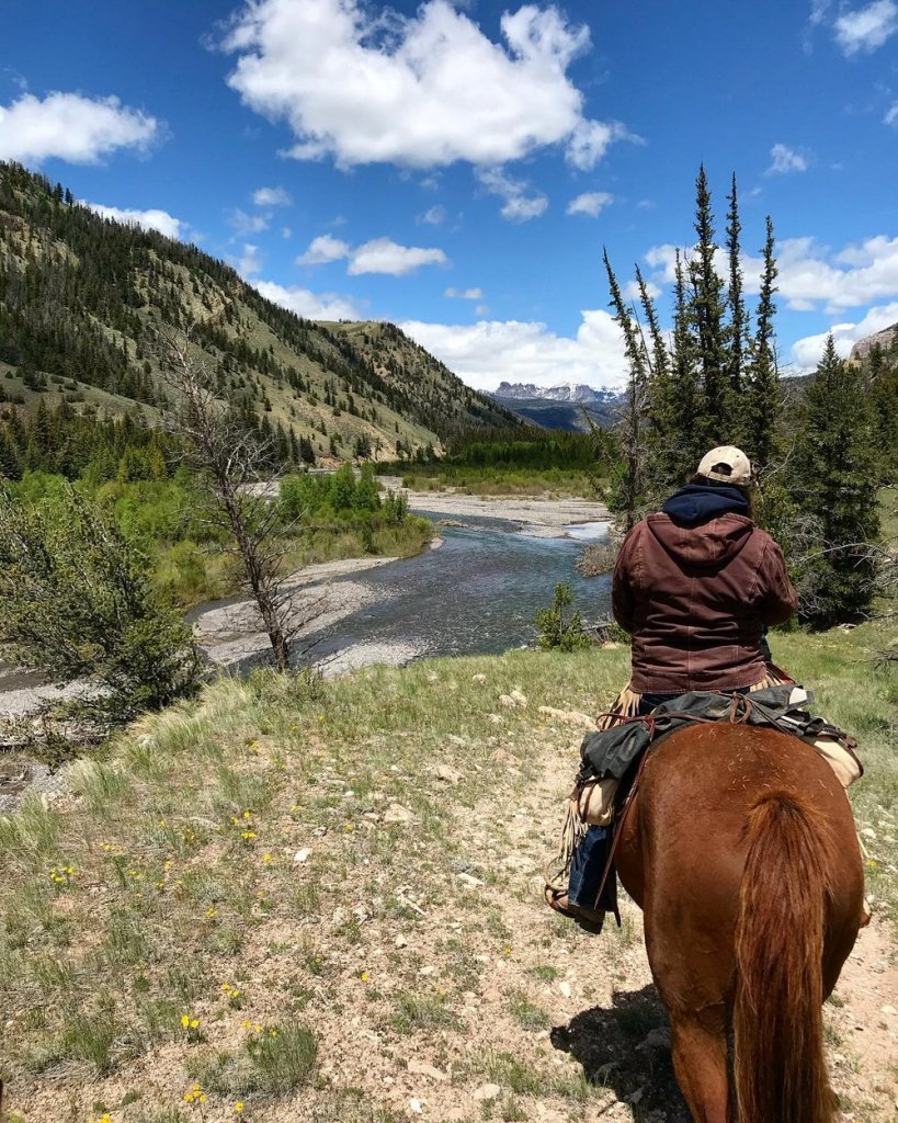 Man on horseback riding through the Wind River Range 