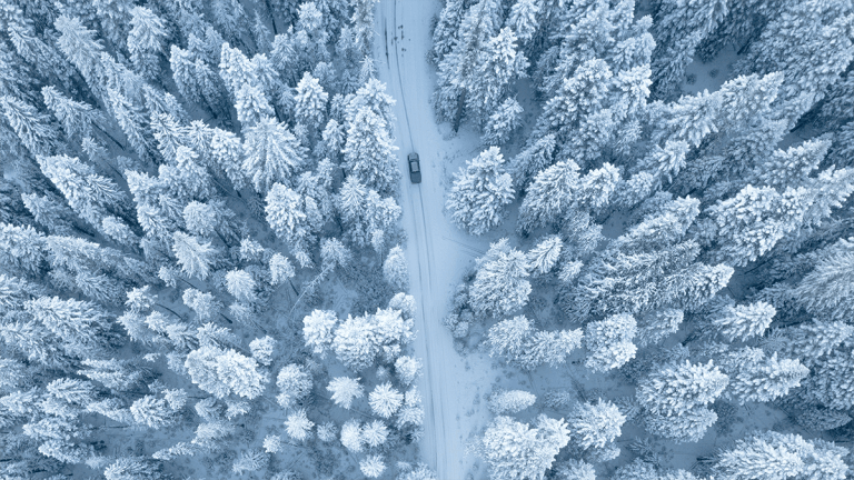 aerial view of car on snowy road