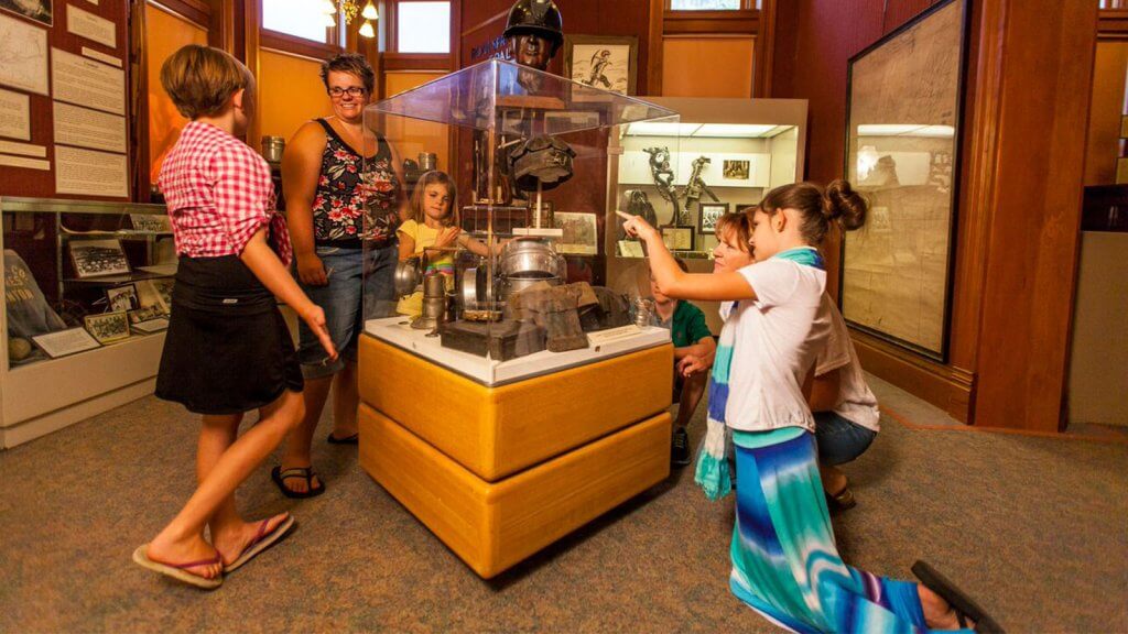 Family having fun at a Wyoming museum, a popular travel activity.