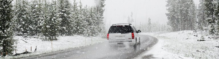 SUV driving down a wintery road