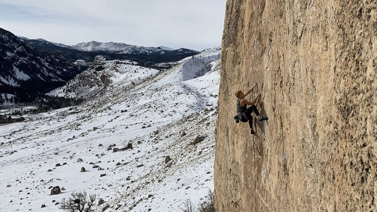 Climber scaling a wall in Sinks Canyon.
