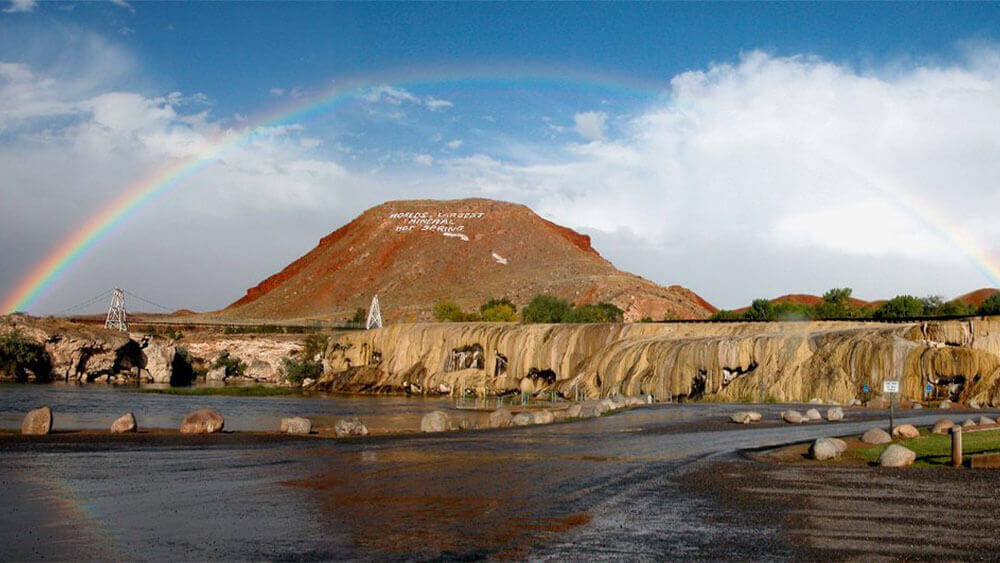 The Hot Springs State Park with a beautiful rainbow over the mountain, a popular thing to do in Thermopolis, Wyoming.
