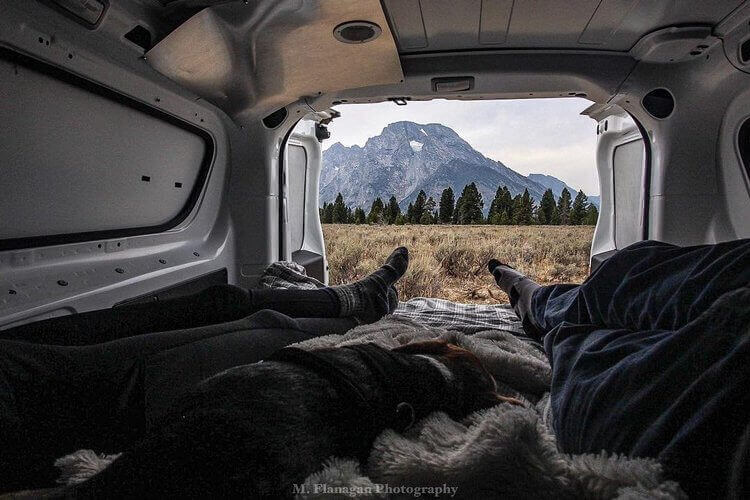 People relaxing and van camping alongside the Grand Tetons, arguably one of the best things to do.