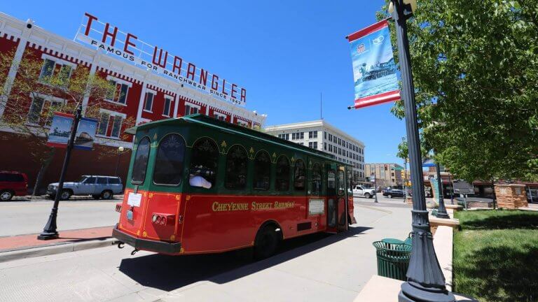 A red trolley driving down streets of Cheyenne's top things to do.
