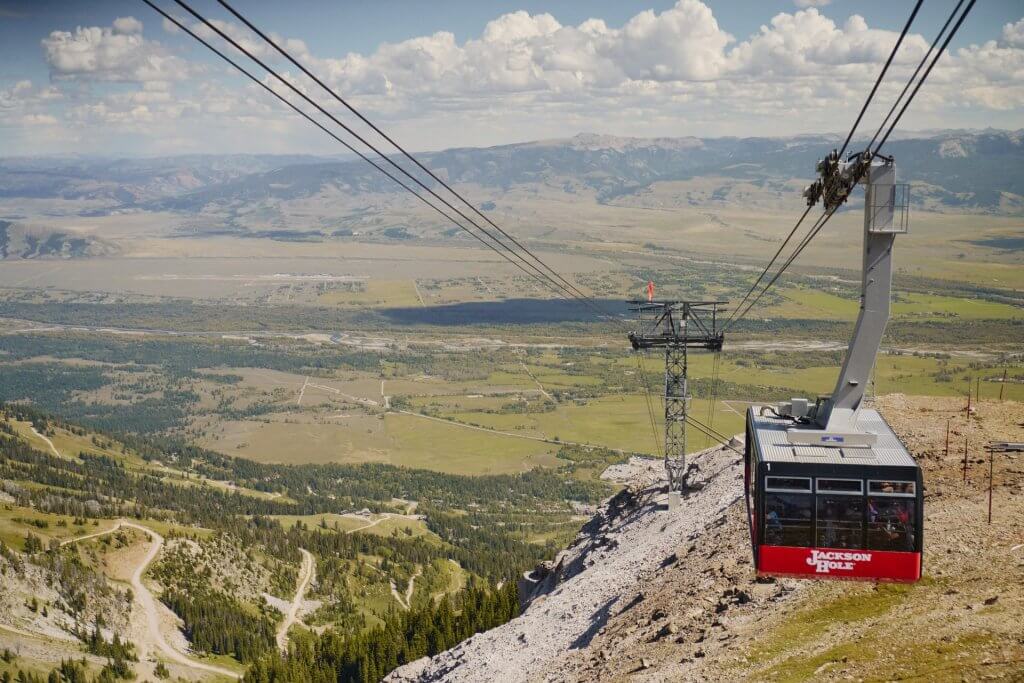 Gondola car riding down a steep mountainside