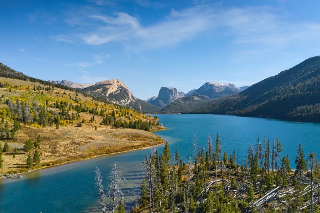 Geographical marker, Square Top Mountain, set against a lake and forests