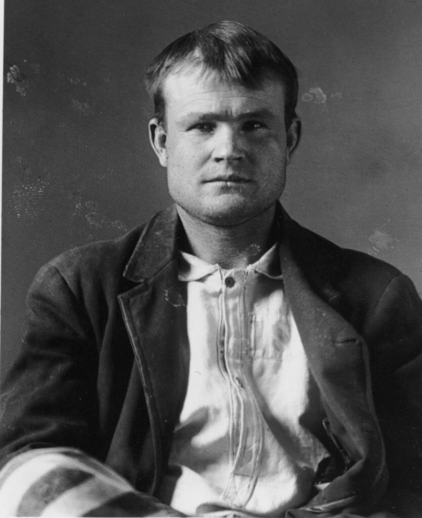 Vintage black and white photograph of famous Butch Cassidy, a well-known outlaw from the late 1800s, with a focused gaze and a determined expression.