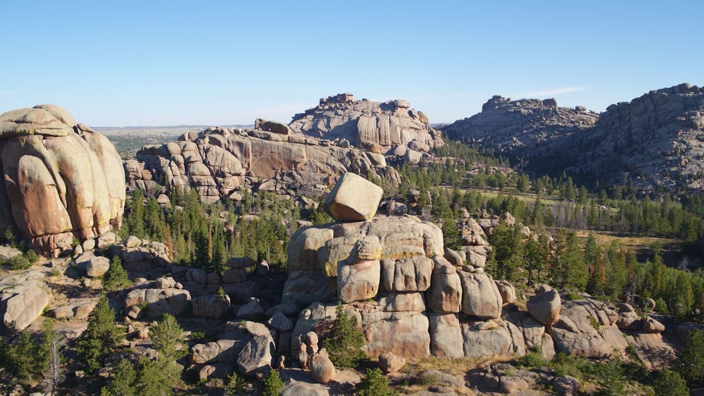 A view of the various large rock formations nestled within a forest of trees at the Vedauwoo Recreation Area.