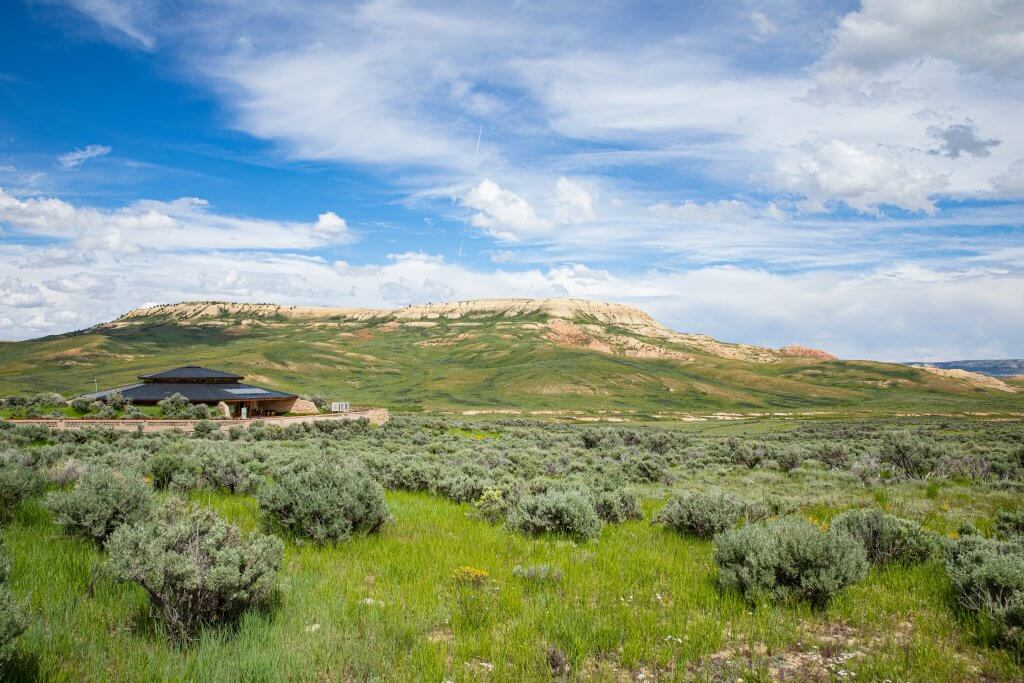 A lush green landscape full of big sagebrush sprawls across The Fossil Butte Nature Trail. 