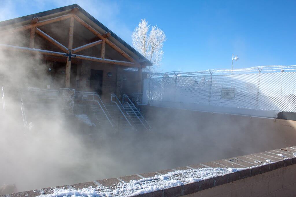 A steamy glimpse of the Hobo Hot Springs, a free public bathhouse in Saratoga, Wyoming. Snow dusts the outside perimeter. 