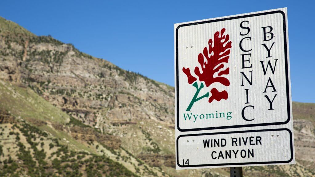 A close-up on the sign signaling the Wind River Canyon Scenic Byway, north of Thermopolis in Wyoming—a byway that leads to the biggest mineral hot spring in the world, Hot Springs State Park. 