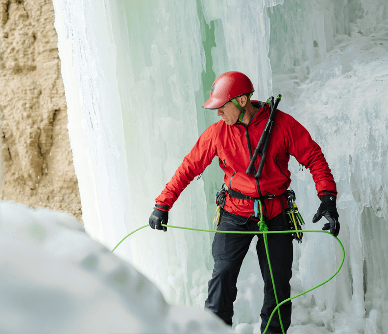 Aaron Mulkey in a red helmet holding an ice climbing rope